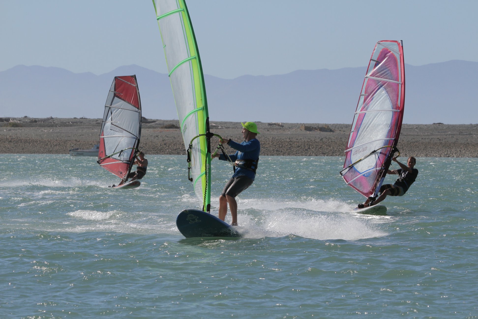 three windsurfers blasting on the Nelson harbour