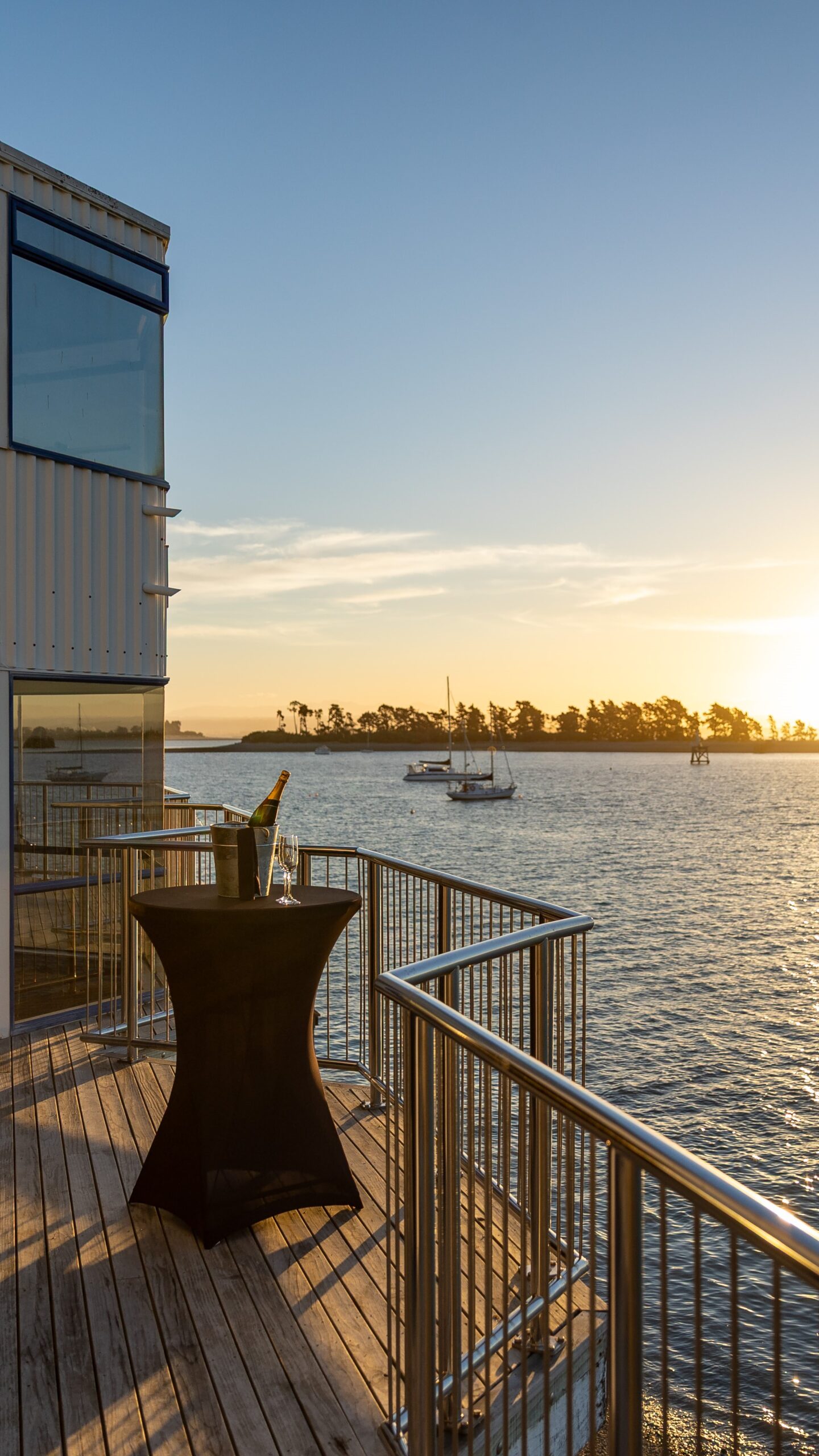 Sunset drinks on the balcony at Nelson Yacht Club's waterfront venue, The Aurora Lounge